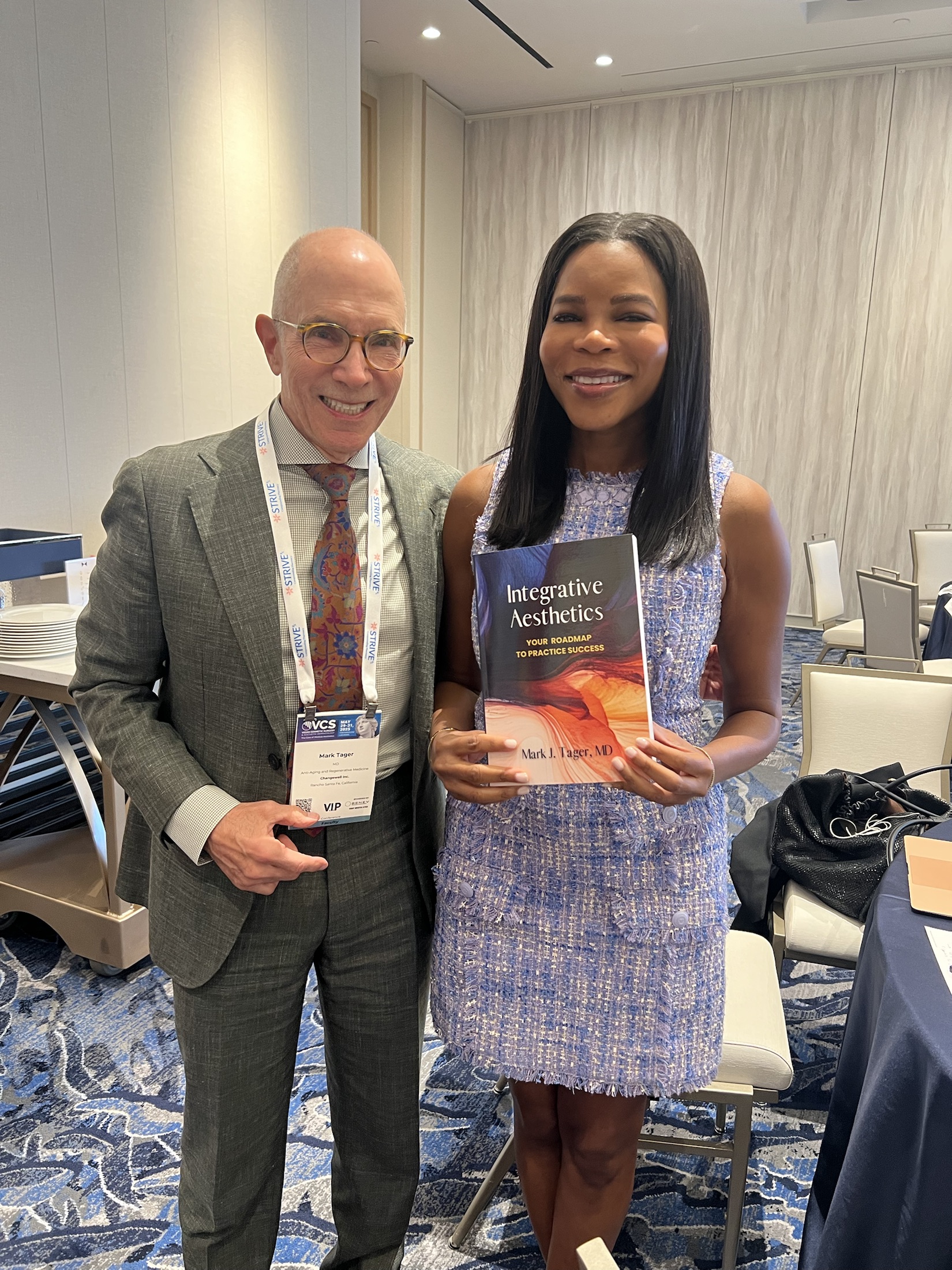 Dr. Tager with a colleague holding Integrative Aesthetics